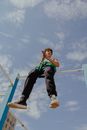 A Boy Sitting on a Monkey Bar
