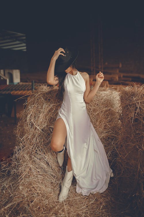 A Woman Wearing a White Dress and Boots 