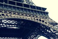 Detailed view of the intricate ironwork of the Eiffel Tower in Paris, showcasing architectural beauty.