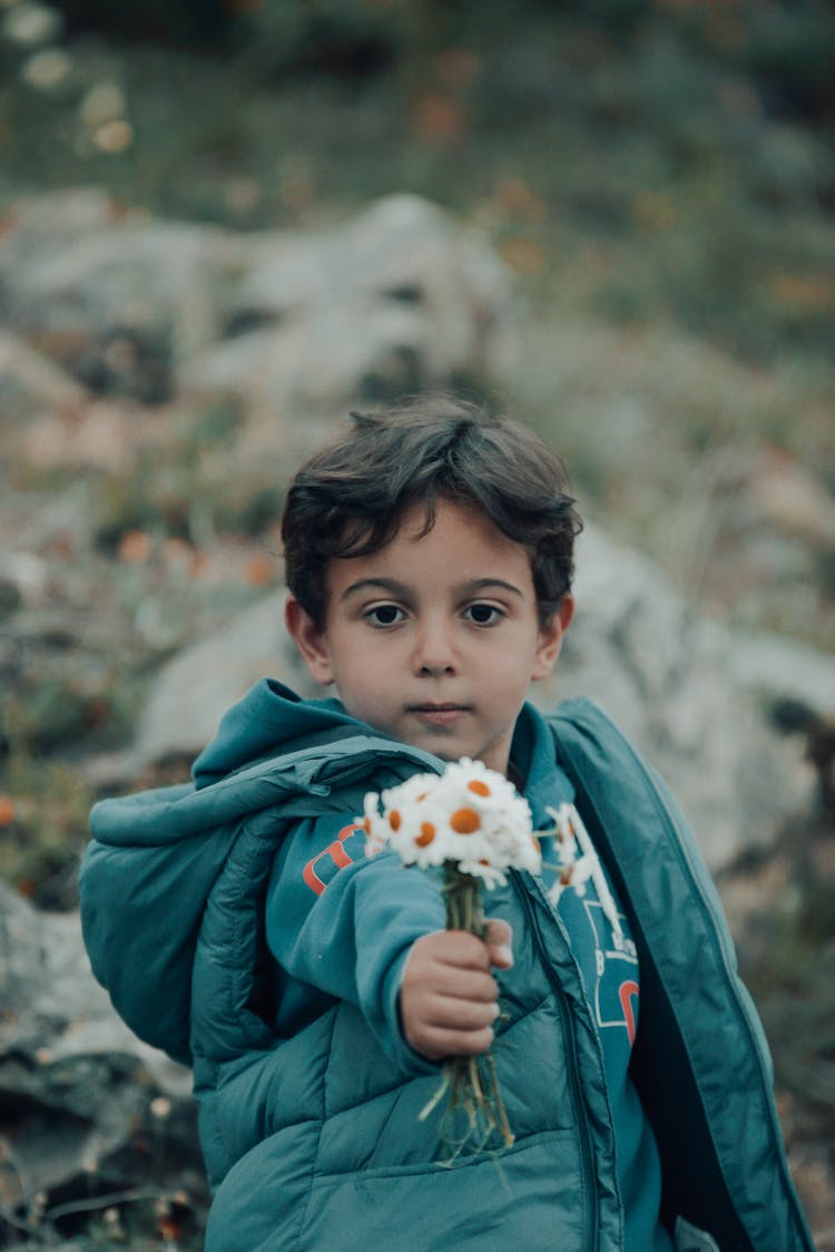 Portrait Of A Boy Holding Flowers