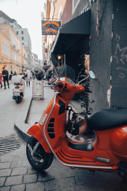 Free Orange scooter parked on a busy street in İstanbul offers a vibrant city scene. Stock Photo