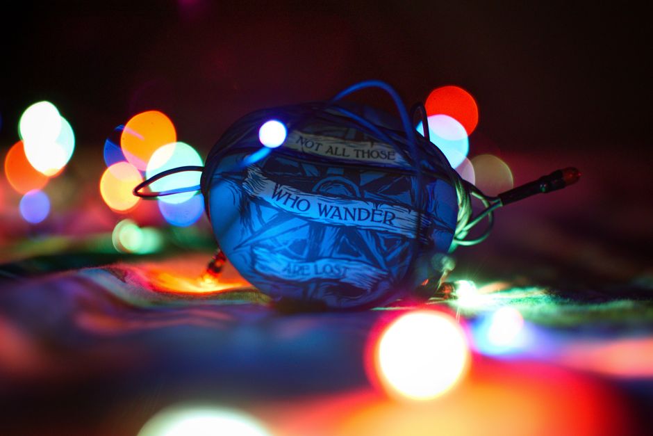 Vibrant bokeh lights surround an object bearing an inspirational quote, creating a captivating and colorful image.