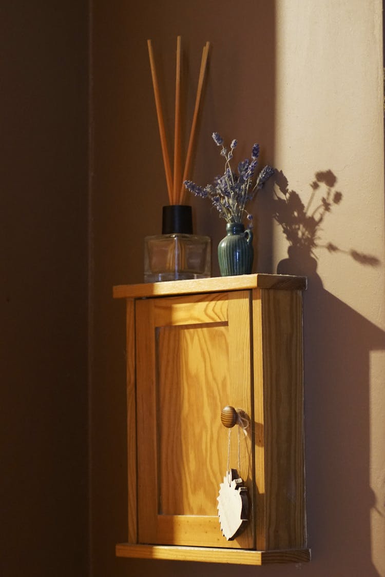 Small Wooden Cabinet On Brown Wall