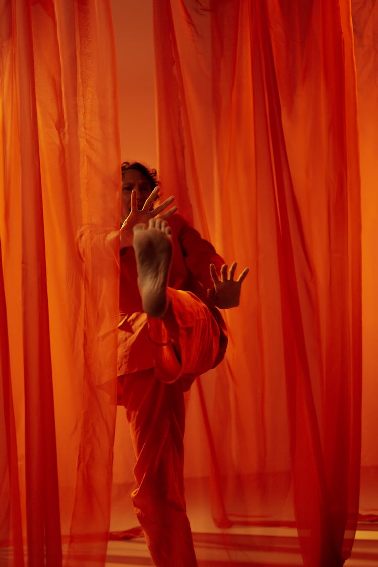 Man Among Red Curtains