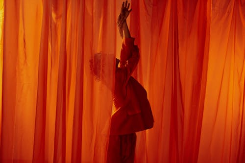 Man among Red Curtains