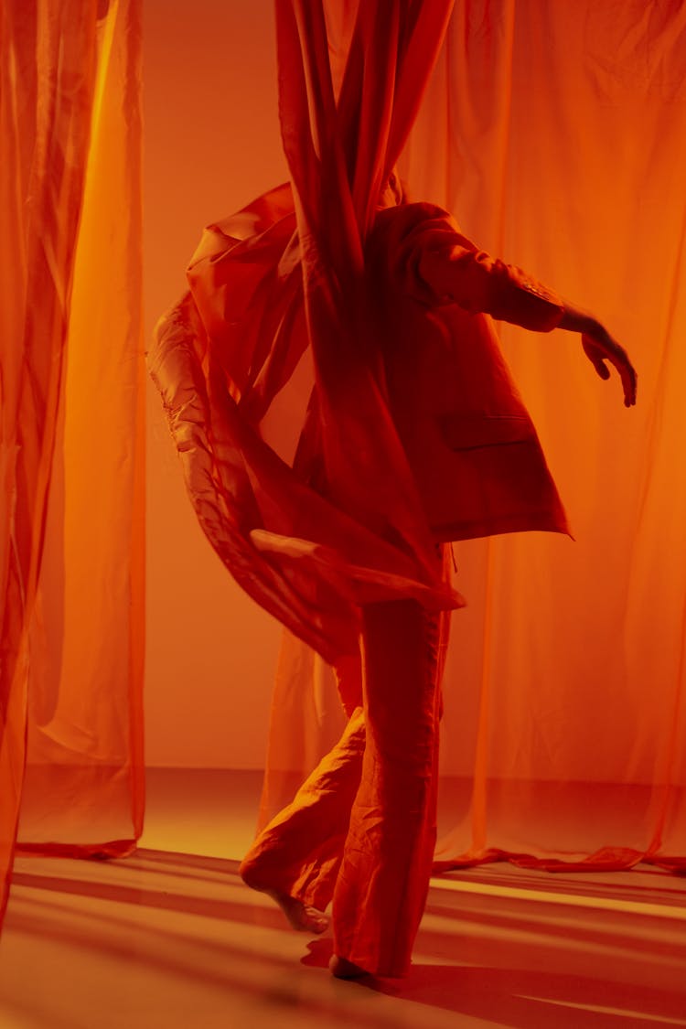 Man Among Red Curtains