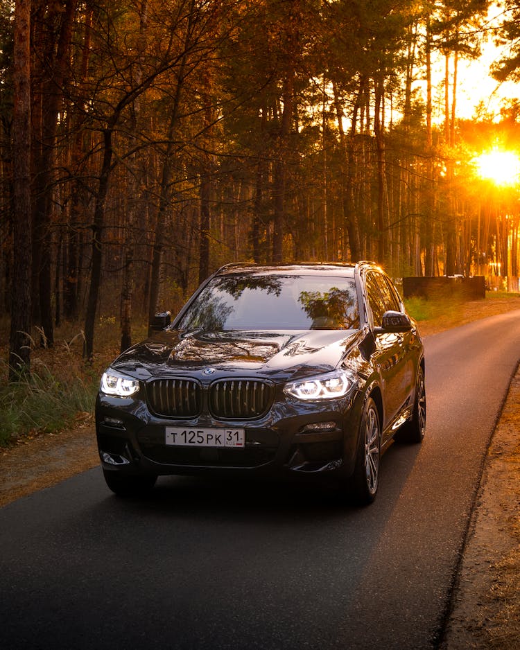 Black Bmw Car On Road During Sunset