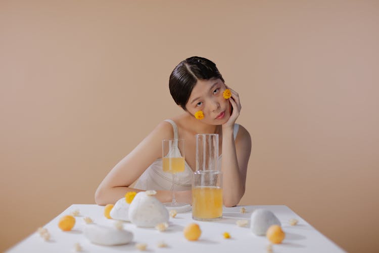 Woman With Hand On Chin Holding Glass