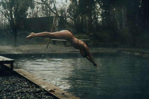 A Woman Diving on a Swimming Pool