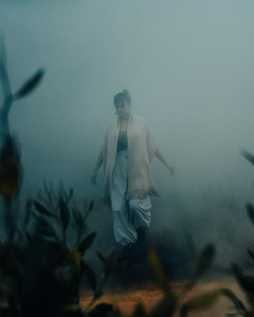 A Woman Walking on a Foggy Weather
