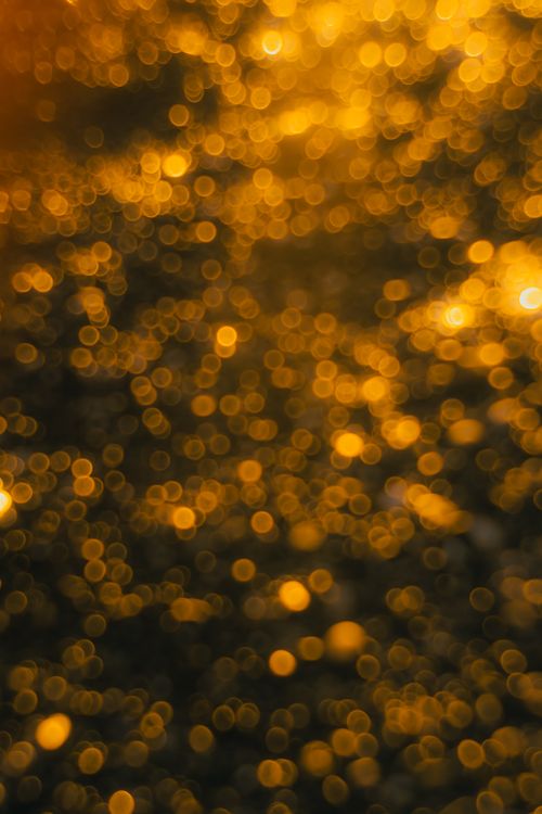 Free A captivating abstract image featuring a golden bokeh pattern, perfect for artistic and design projects. Stock Photo