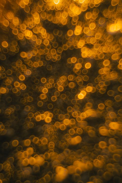 Free A captivating abstract of golden bokeh lights, perfect for festive themes and backgrounds. Stock Photo