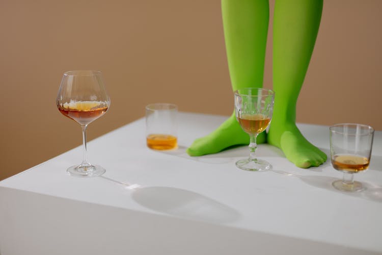 Legs In Green Tights On Table