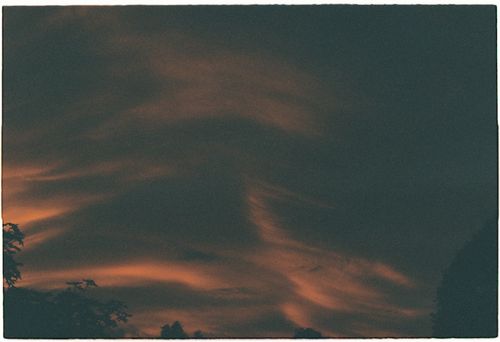 Free Capture of a dramatic cloudscape at twilight with dark and orange hues. Stock Photo