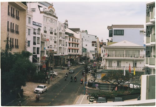 Cars Parked on Side of the Road Near Buildings