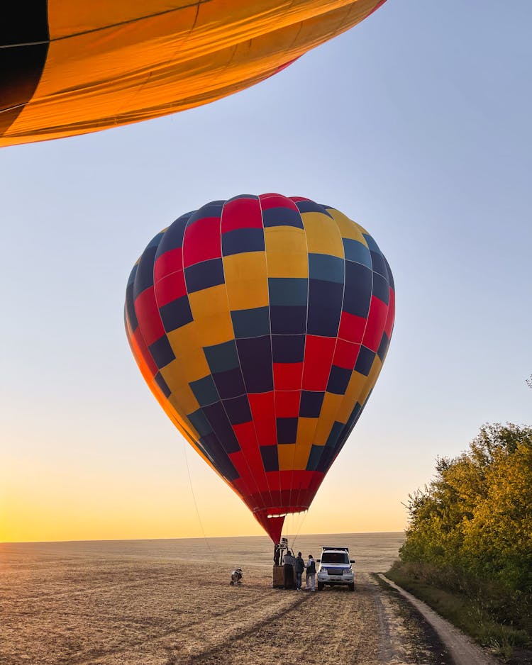 Parked Car Beside A Hot Air Balloon