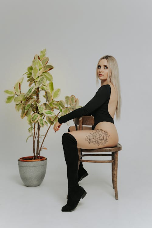 Woman with Tattoo Sitting on Chair