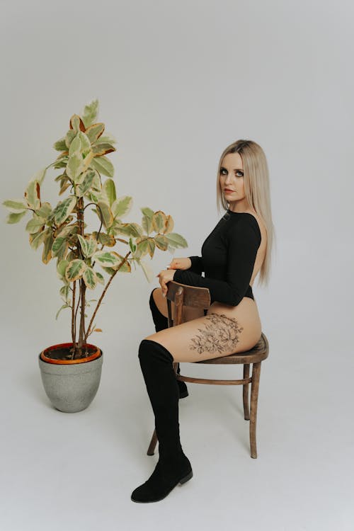 Sexy Woman Sitting on a Wooden Chair