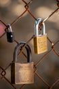 Brown Padlock on Gray Metal Fence