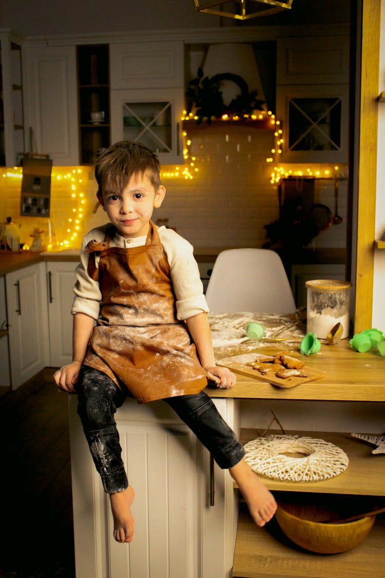 Boy Sitting On Kitchen Counter