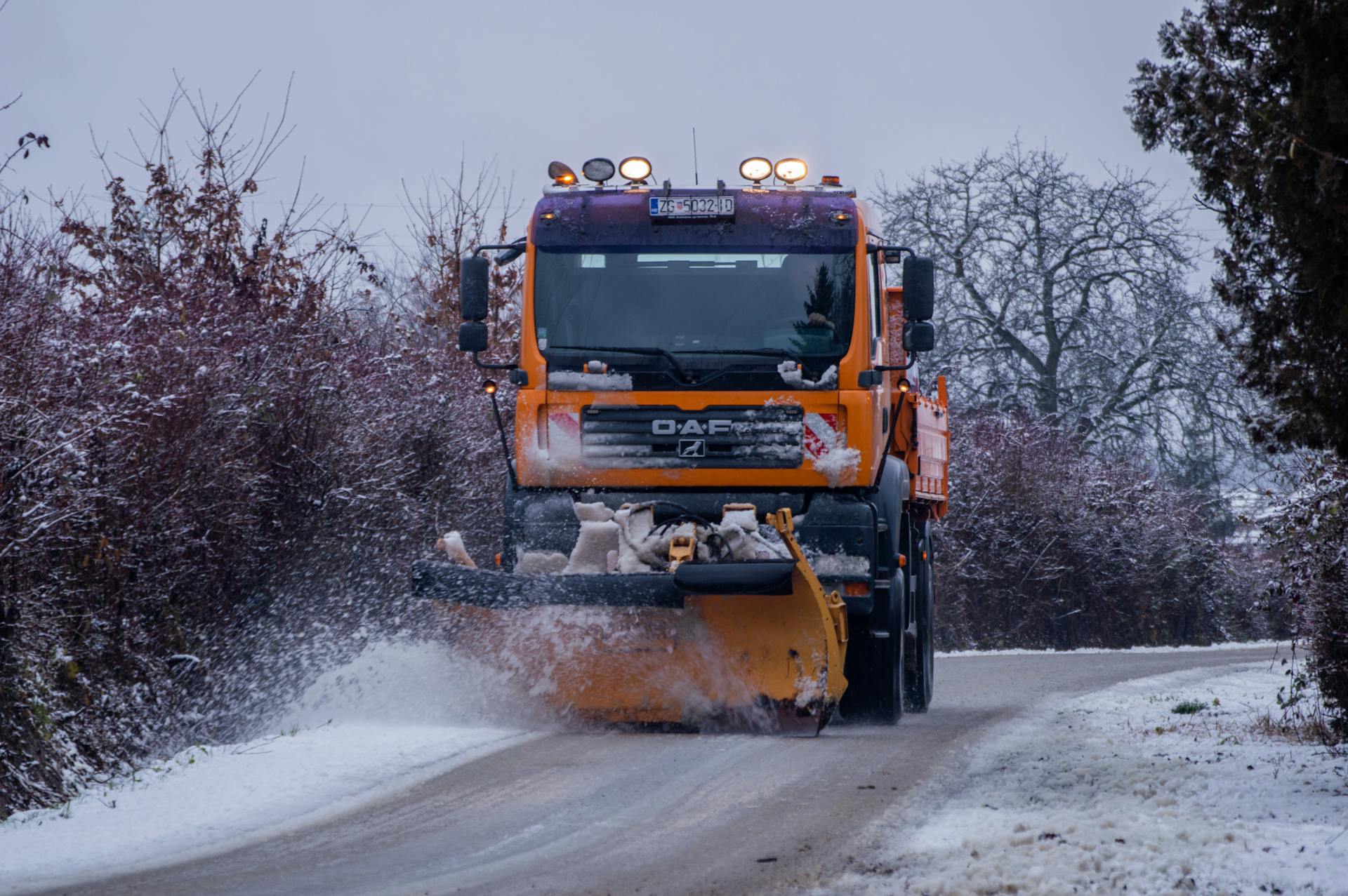 A Truck Plowing a Snow on the Road