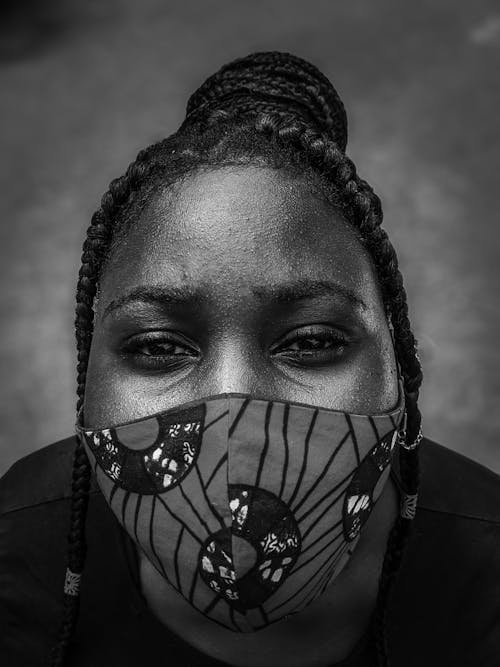 Grayscale Photo of a Woman Wearing a Face Mask