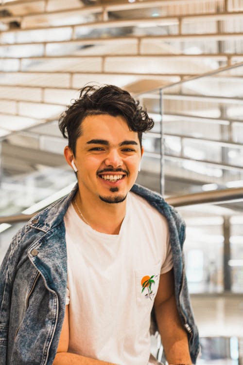 A Smiling Man in White Shirt and Denim Jacket