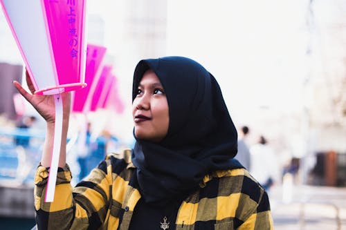 Free Woman in Black Hijab Holding a Hanging Lantern Stock Photo