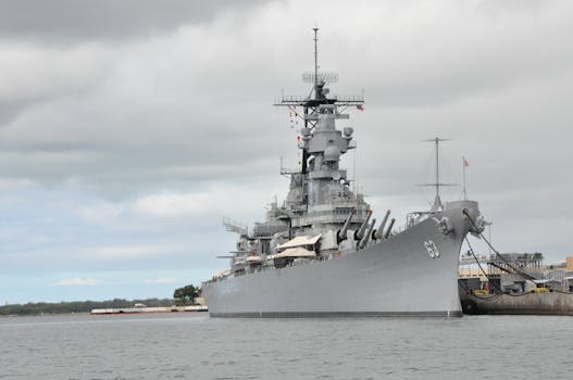 Photo by John Wolf USS Missouri battleship moored at Pearl Harbor in Hawaii under a cloudy sky.