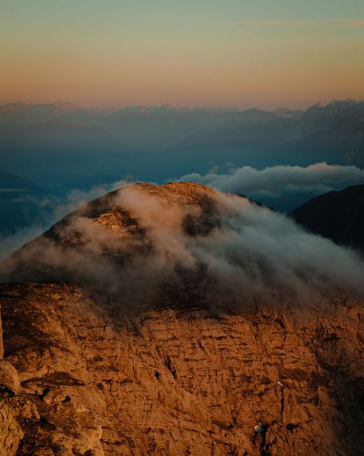Captivating aerial view of misty mountains at sunset in Zirl, Tirol, Austria.