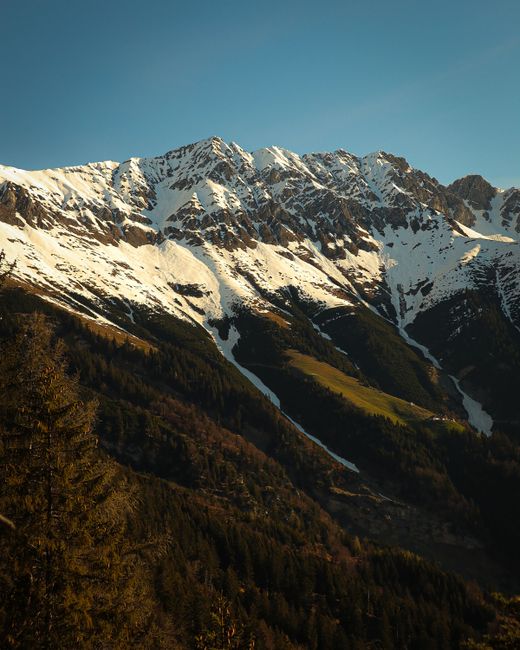 Stunning view of the snow-capped Alps in Tirol, Austria, capturing a tranquil winter landscape.