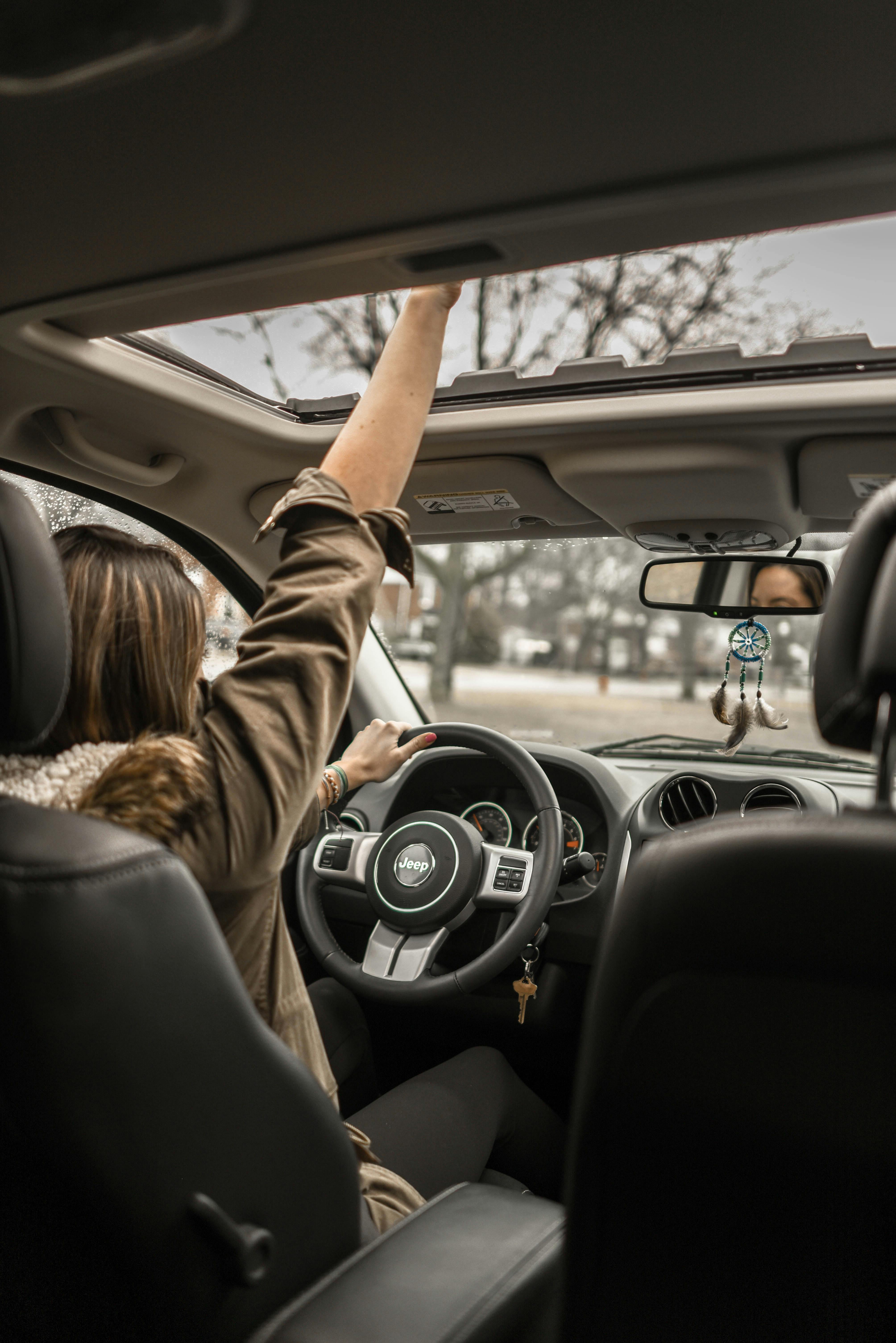 photo of woman driving car