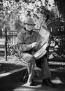 Man Sitting and Playing Harp