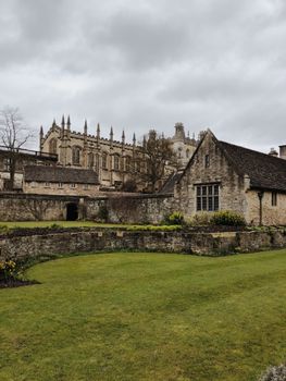 Gothic architecture of Christ Church College, Oxford with lush greenery.