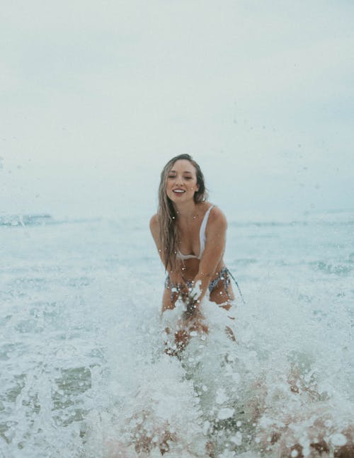 Free A Woman in White Bikini on the Beach Stock Photo