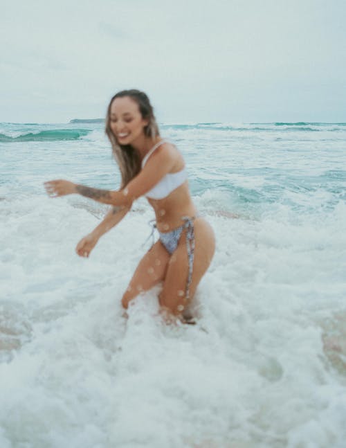 Woman in Bikini Playing in the Sea 