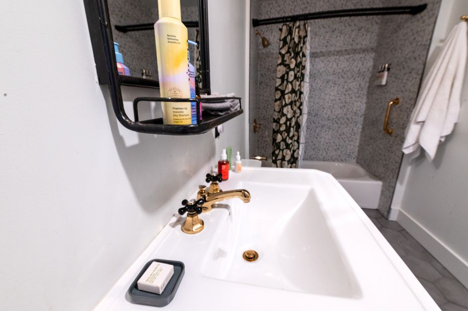 Contemporary bathroom interior featuring gold fixtures and stylish decor.