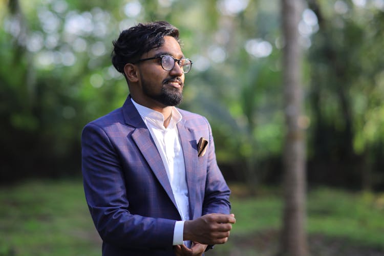 Young Hindu Man In Eyeglasses Wearing Elegant Suit