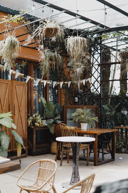Free Cozy outdoor seating area in Bảo Lộc, Lâm Đồng, with lush plants and rustic decor. Stock Photo