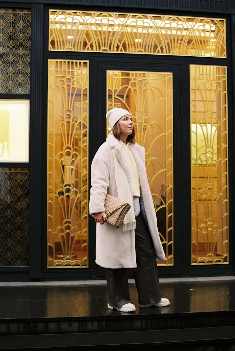 A Woman Standing Outside A Glass Door