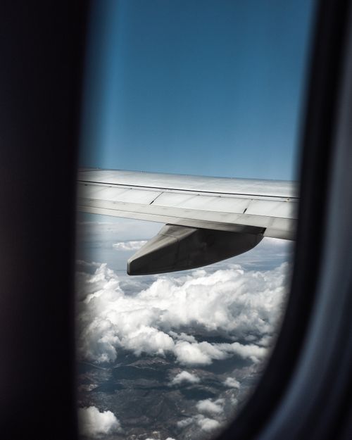 Free Scenic view of clouds and airplane wing through window, captured during flight. Stock Photo