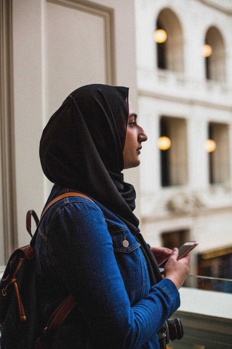 Woman In Black Kerchief Standing On Balcony Of College