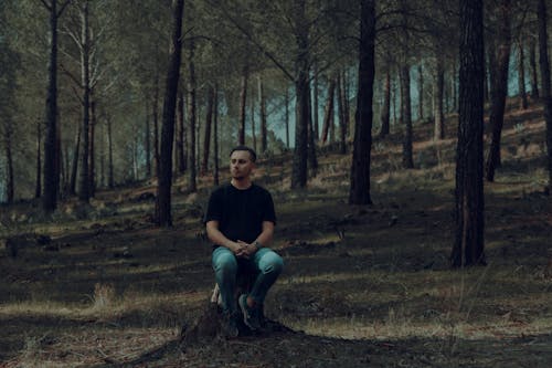 Man Sitting in Forest