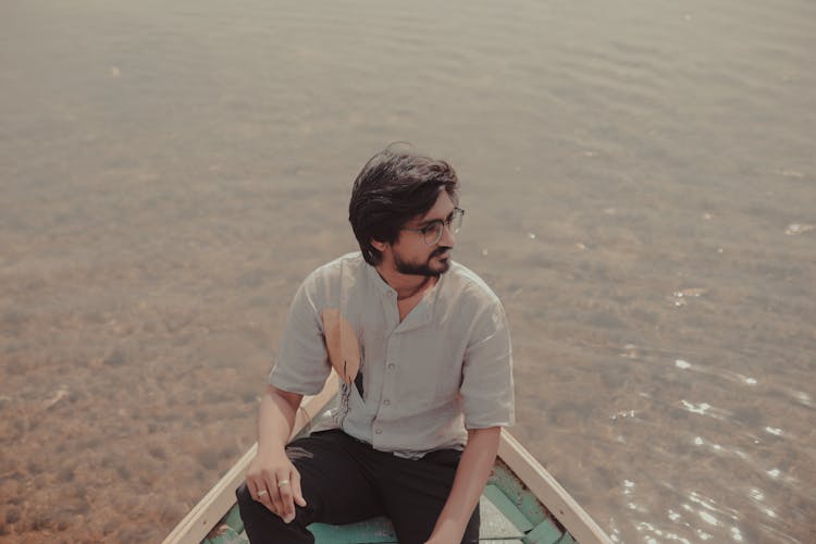 A Man Sitting On A Boat