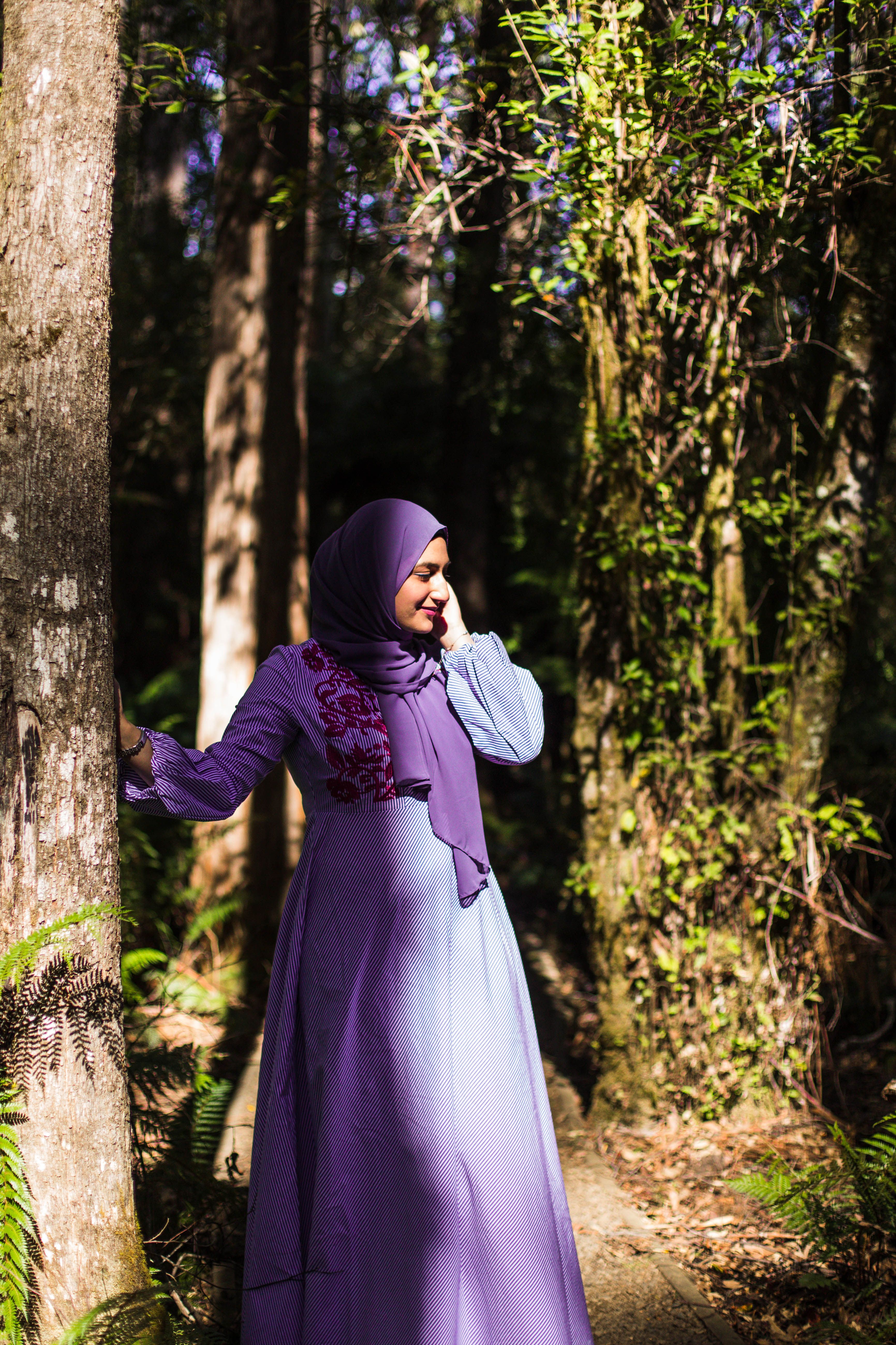 A Woman in Purple Dress Standing Beside Tree · Free Stock Photo