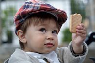 Boy in White Hoodie Holding Brown Ice Cream Cone