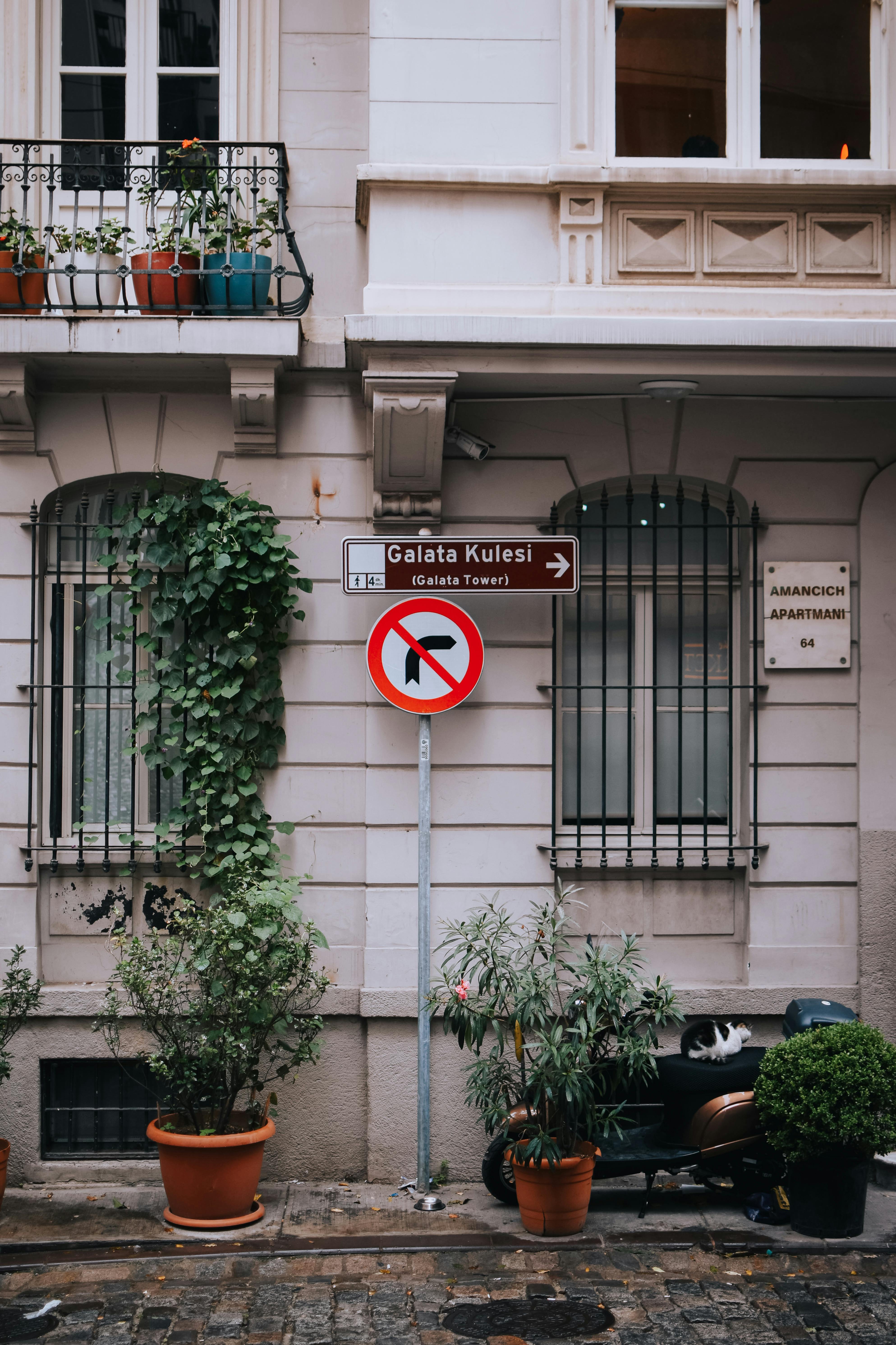 Discover the historic Galata Tower with this street sign in Istanbul's urban landscape.