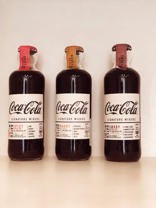 Bottles of Coca Cola Signature Mixers on White Surface