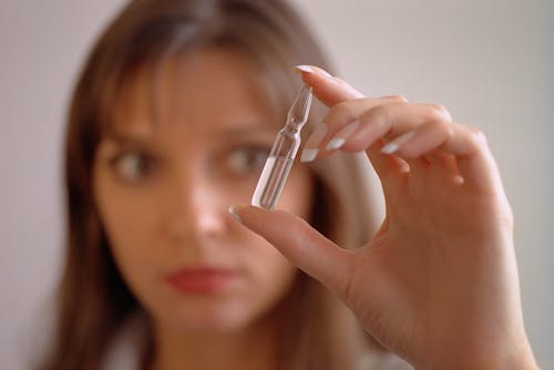 A Woman Holding an Ampoule
