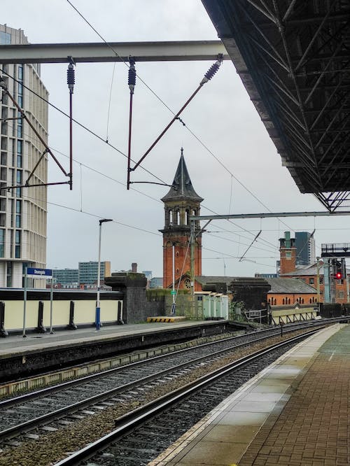 Photo of a Train Station Near a Tower